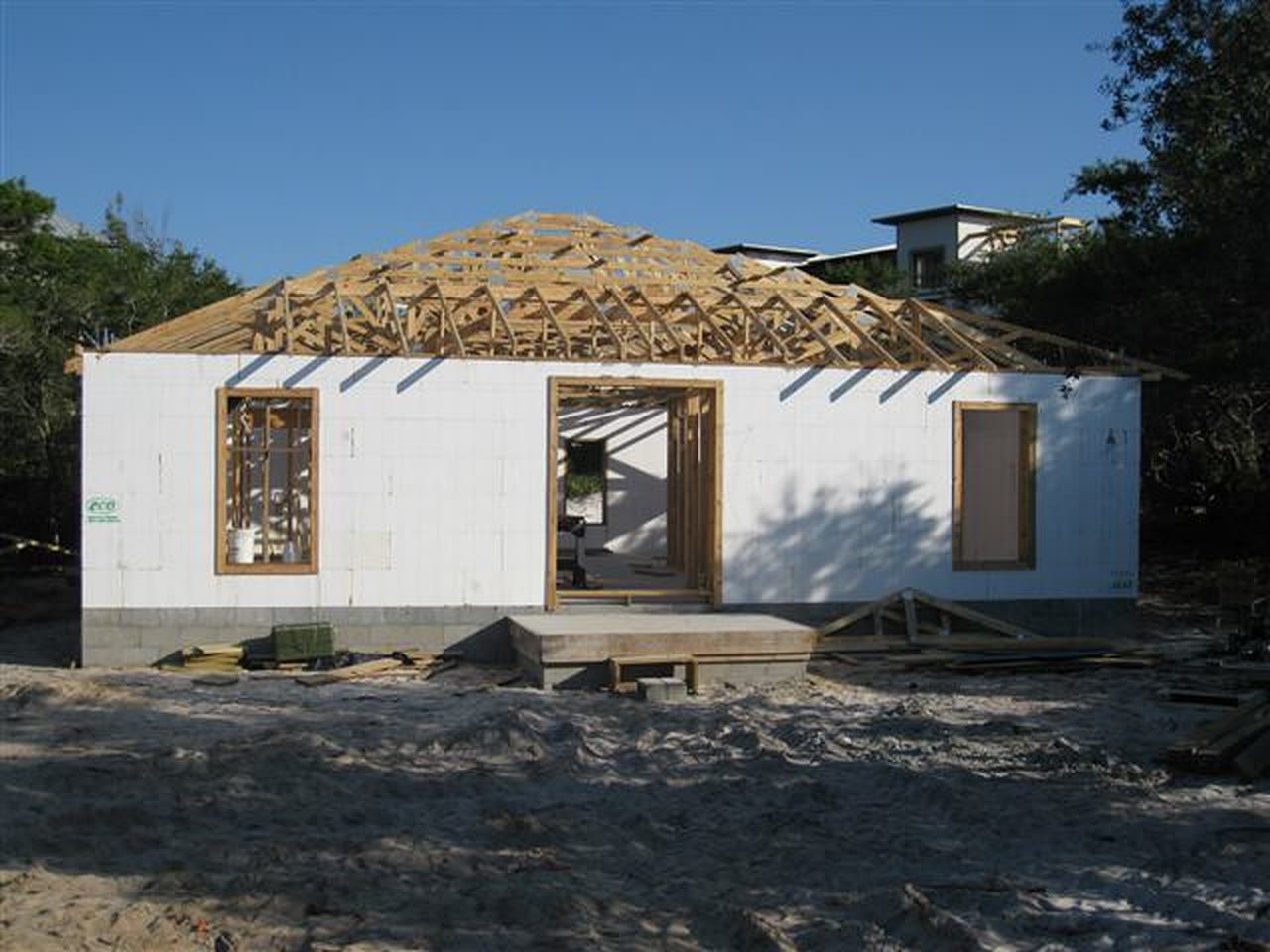 Roof trusses set on finished ICF walls with window openings bucked out